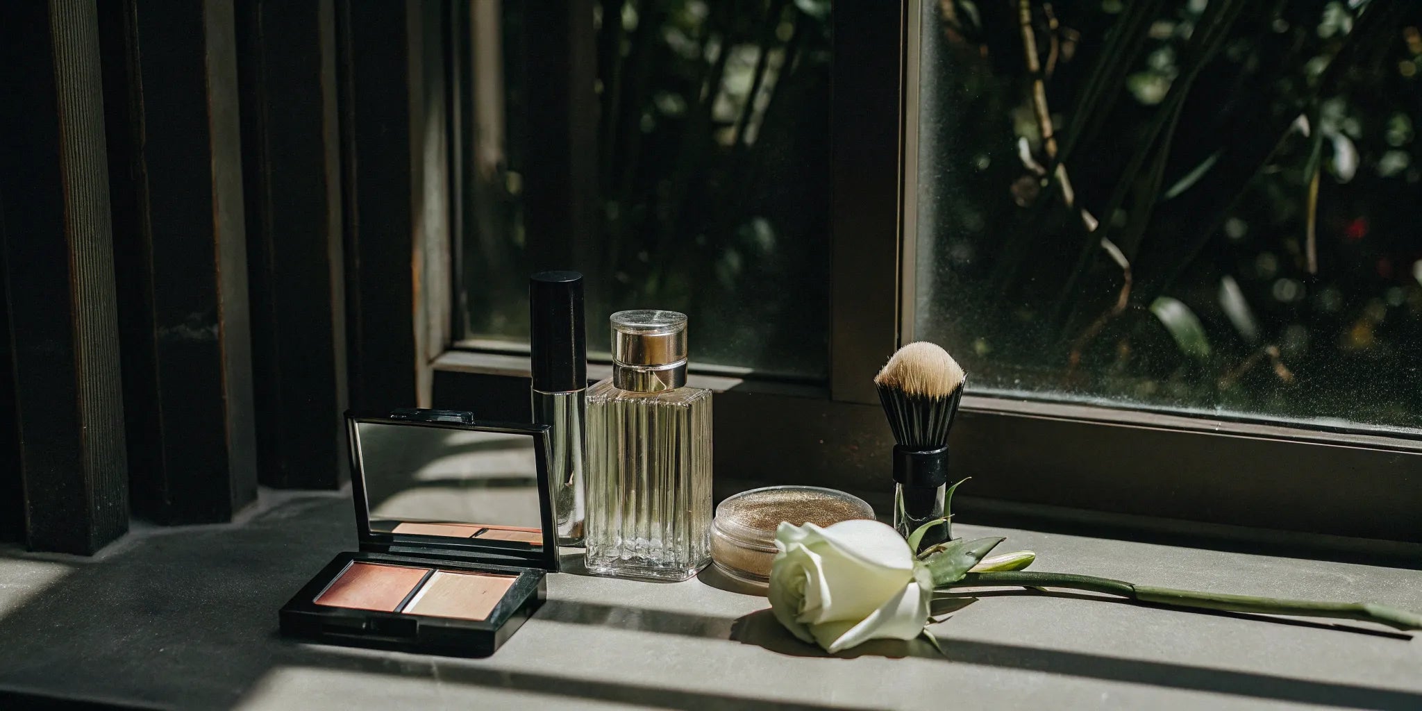 A selection of makeup from the best paraben-free brands, including blush, powder, and a brush.