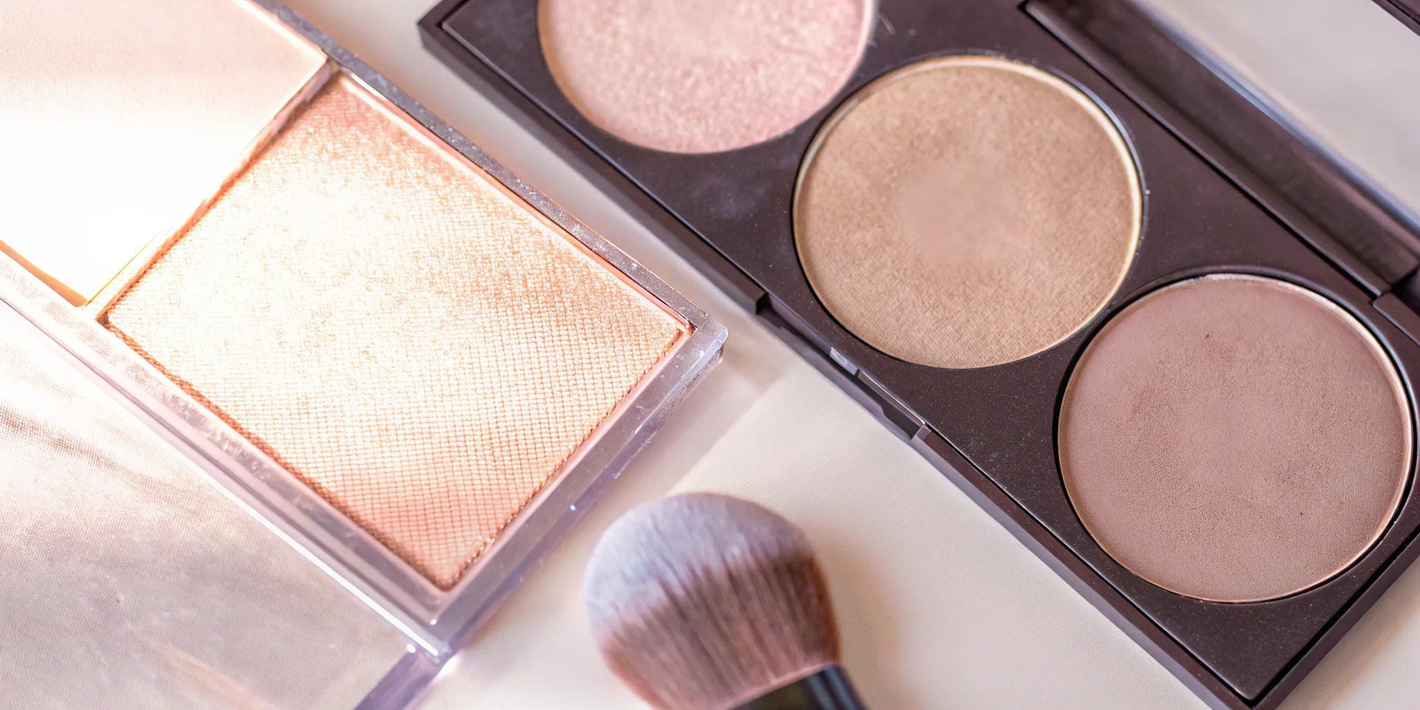 Powder bronzers and a makeup brush for a natural, sun-kissed tan.