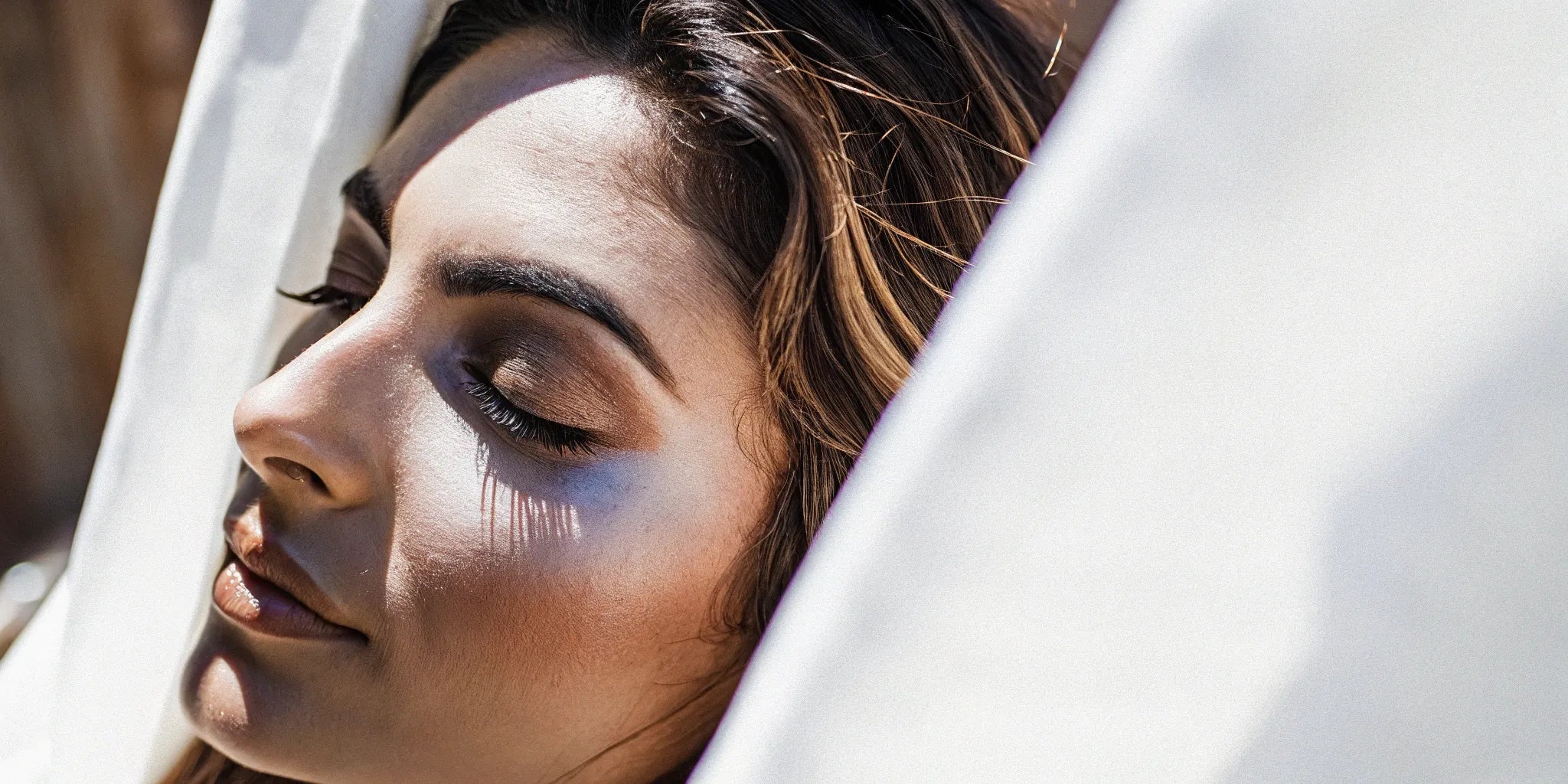 Woman with a radiant makeup look using eyeshadow as blush and highlighter.