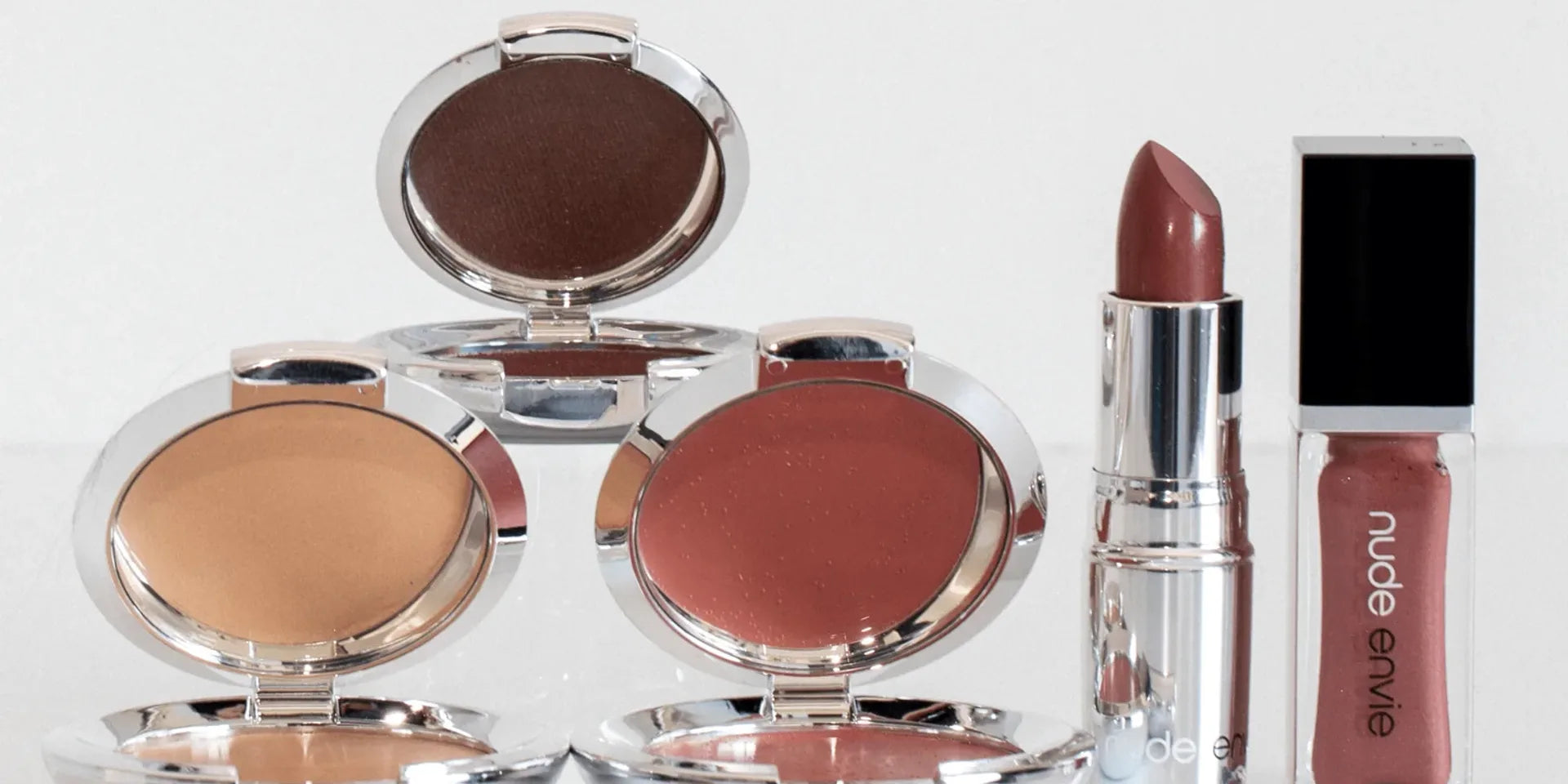 Luxury nude makeup gift collection featuring coordinated lip and eye products in warm neutral tones