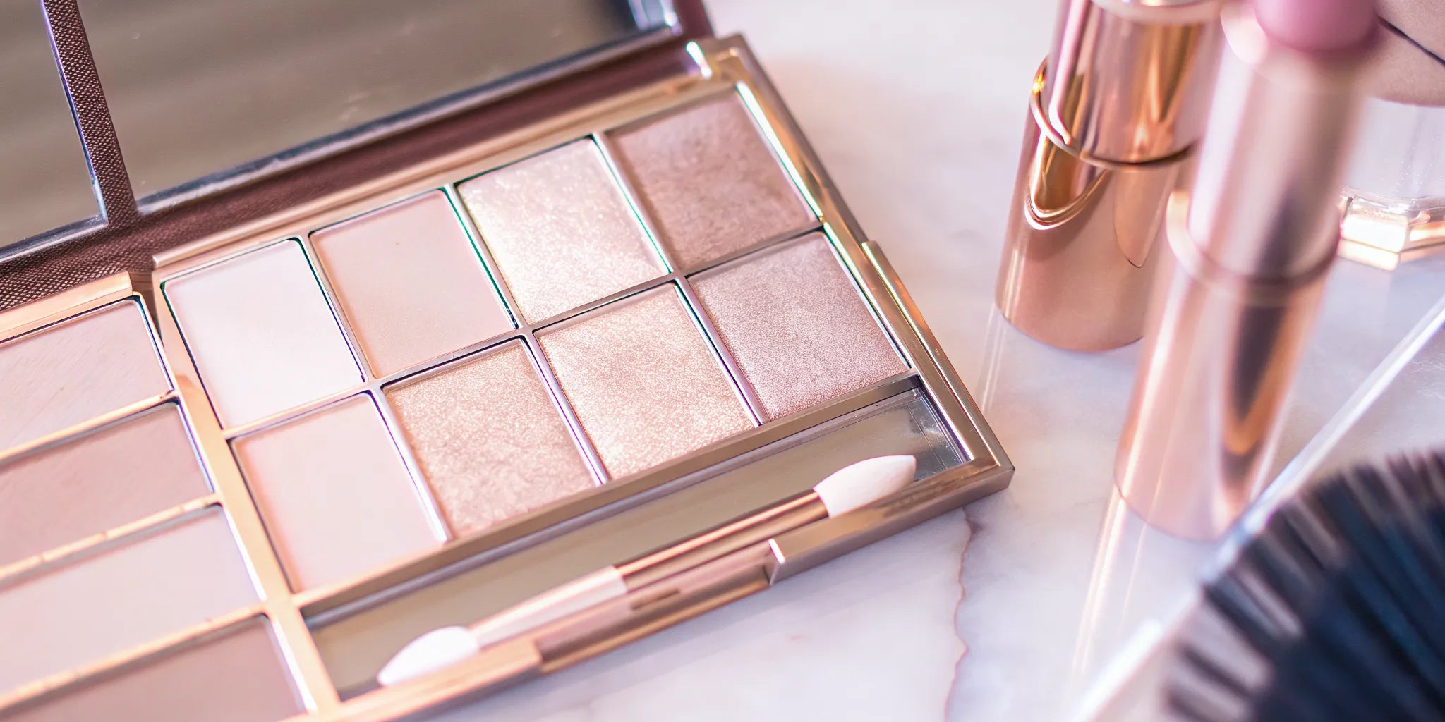 Nude Envie cream blush and highlighter on a vanity table with soft lighting