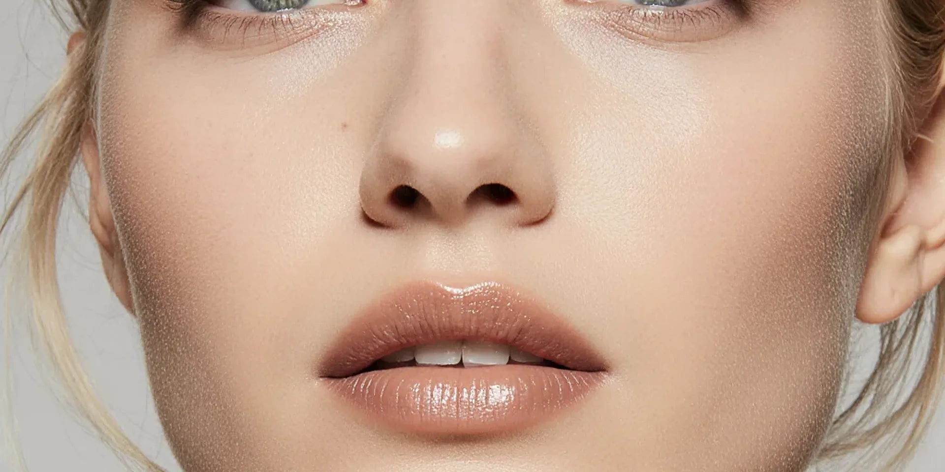 Close-up beauty portrait highlighting soft nude eye makeup on hooded eyes.