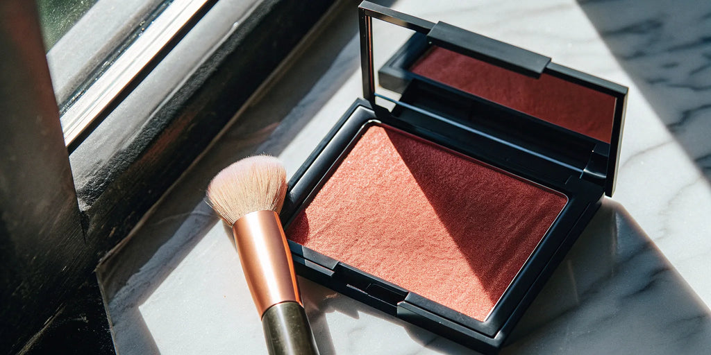 A natural powder bronzer and brush for creating a healthy glow.