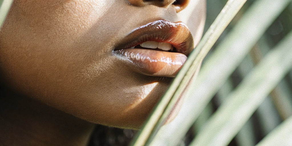 Close-up of lips wearing a smooth, high-shine, non-sticky lip gloss.