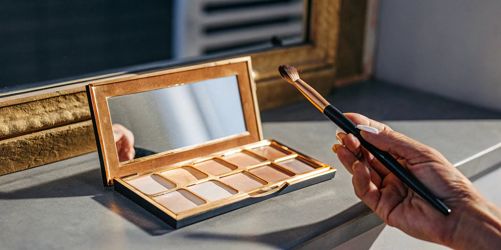 Open eyeshadow palette and brush for simple eye makeup for mature eyes.