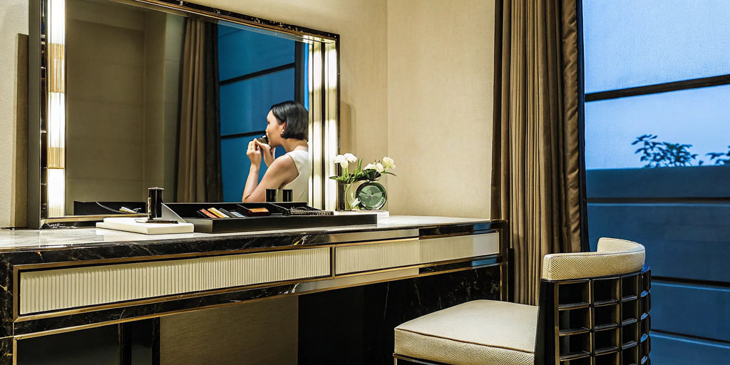 Mature woman applying the best eyeshadow for hooded eyes over 60.