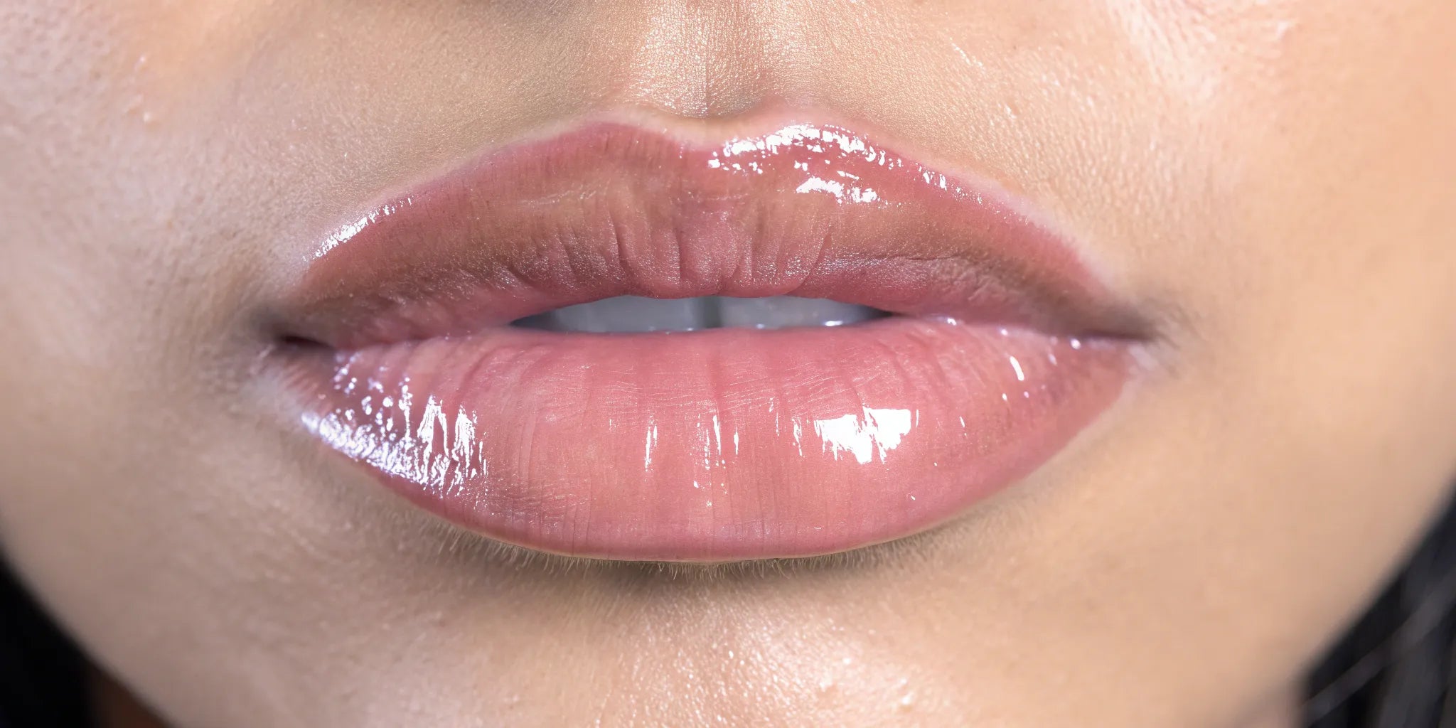A close-up of lips showing how to get a mirror-like glassy lip look.