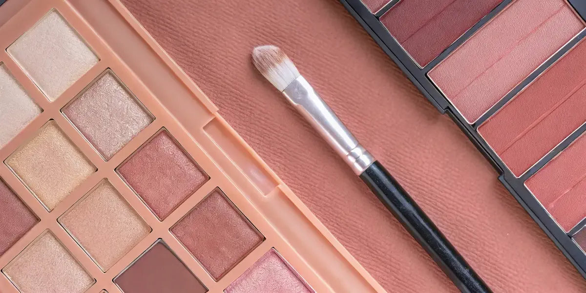 Warm nude shades and brushes for a natural eye makeup look