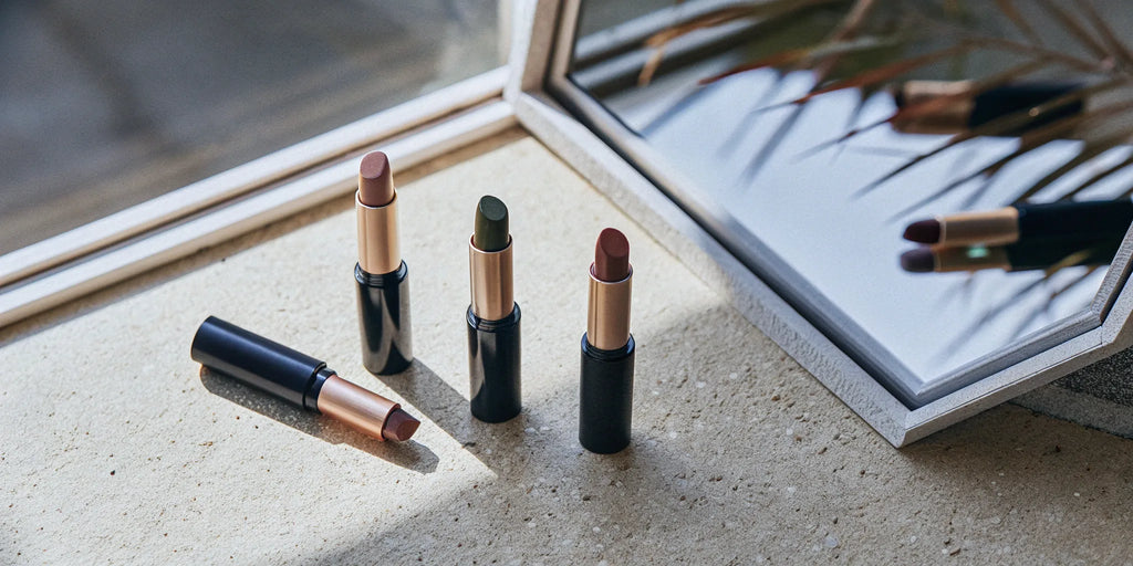 A selection of top-rated organic eyeshadow sticks in neutral and green shades.