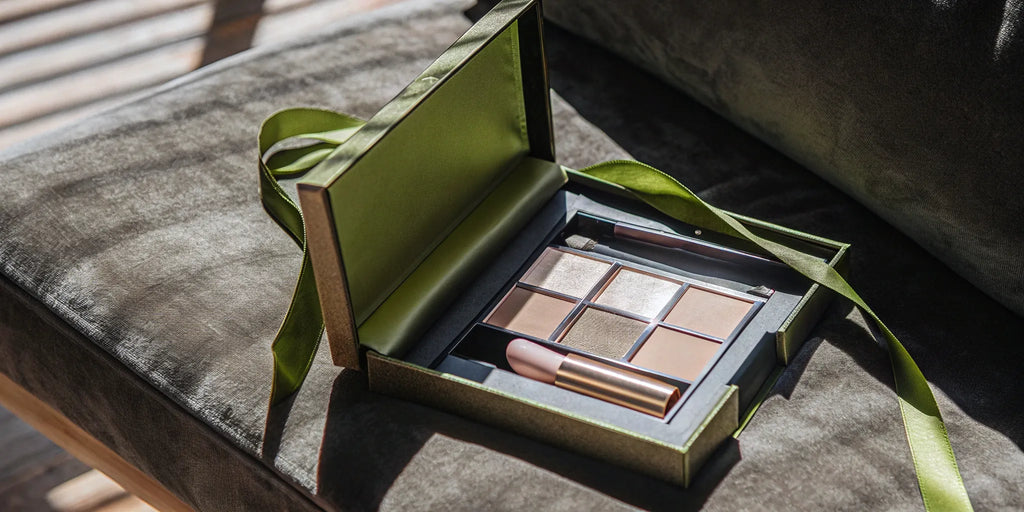 A gift box of luxury beauty stocking stuffers including lipstick and eyeshadow.