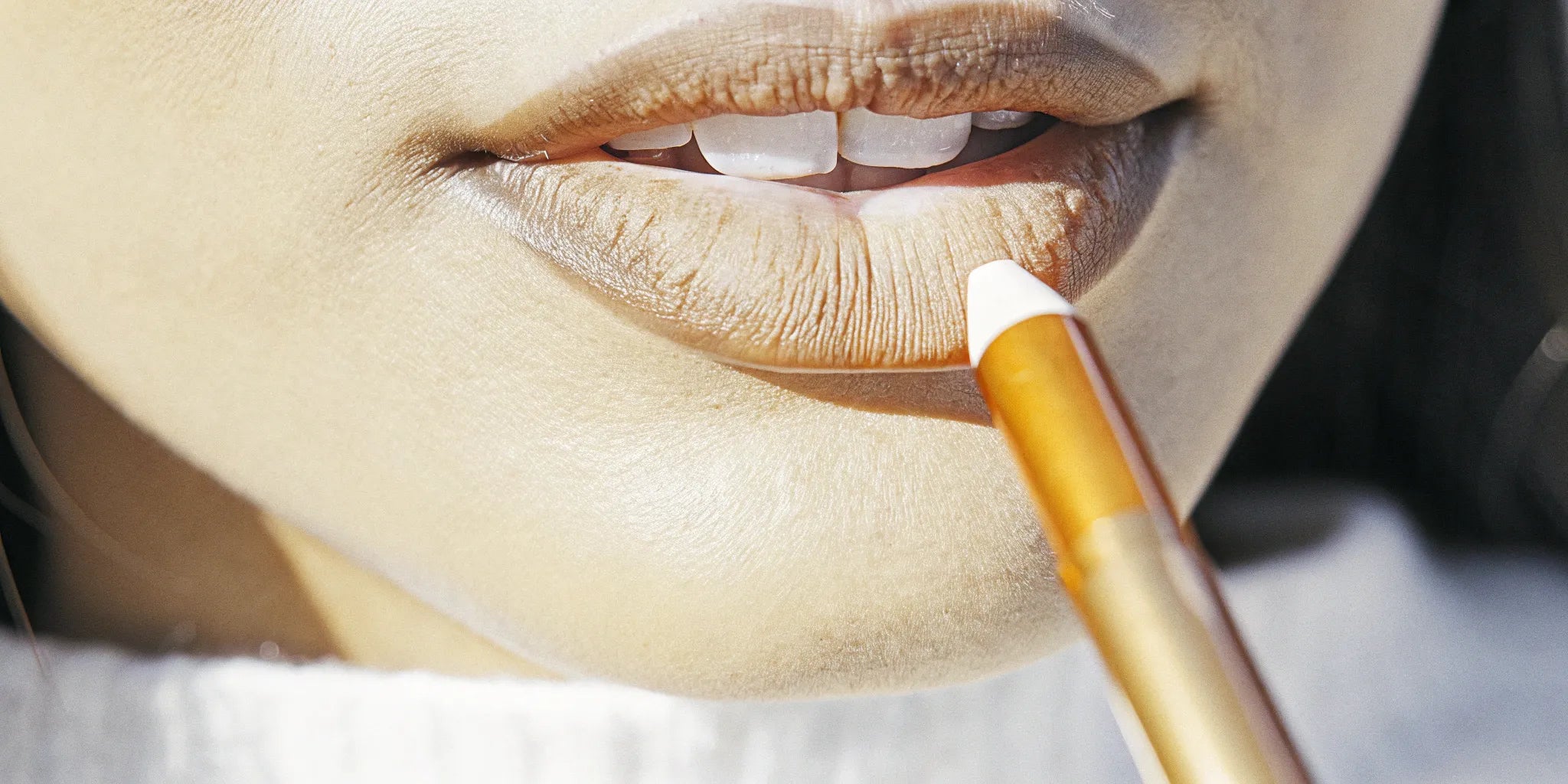 Close-up of a mocha lip liner precisely defining the shape of the lips.