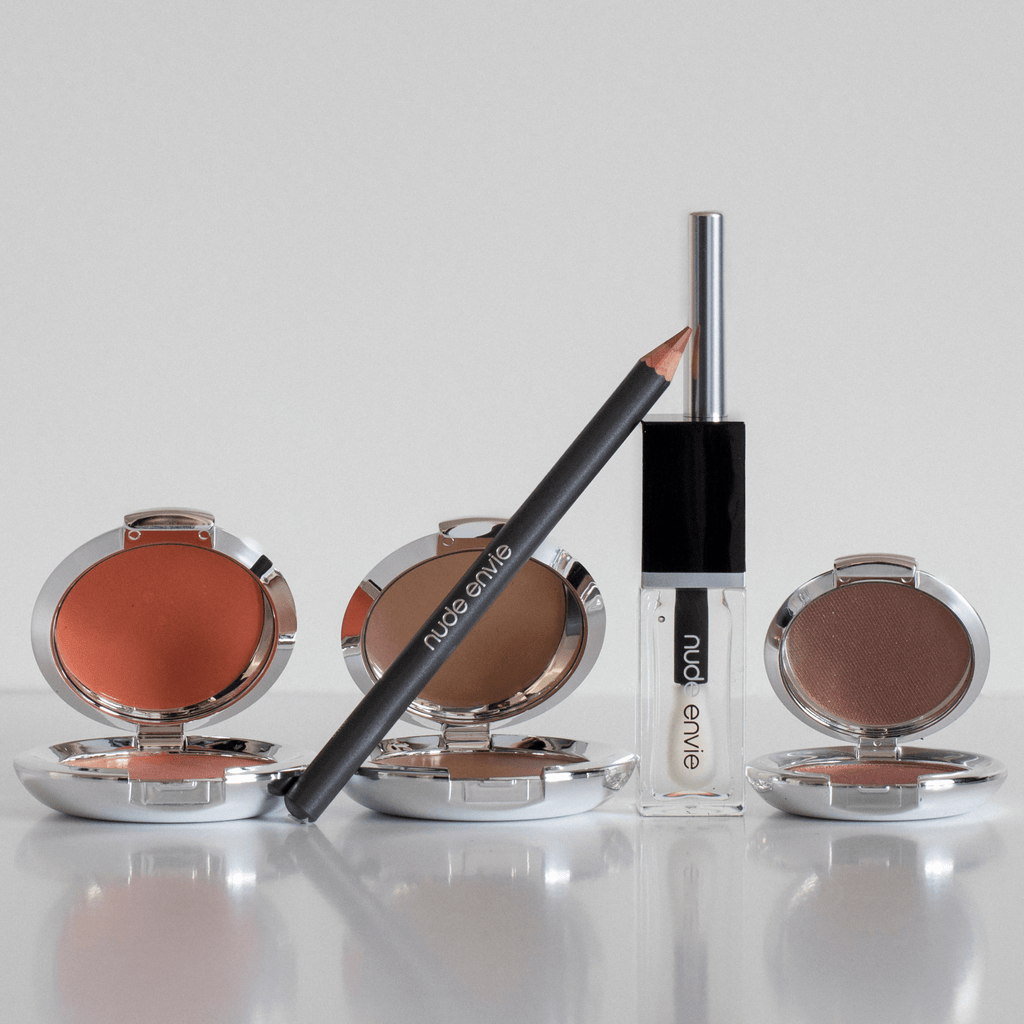 Soft glam makeup collection showcasing a radiant look featuring glowing skin, a warm pink blush with gold shimmer, defined brows, soft brown eyeshadow, subtle winged liner, fluttery lashes, and a nude pink lip, perfect for any occasion, emphasizing natural beauty and elegance